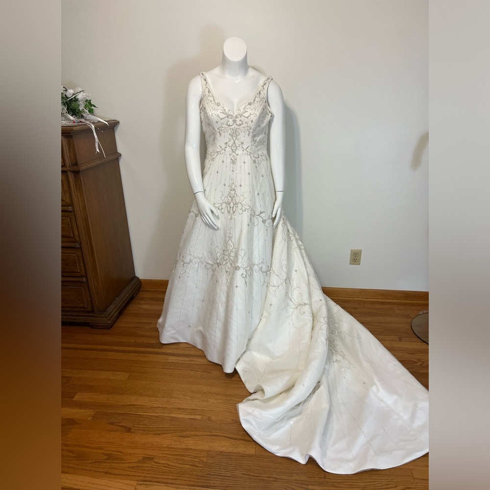 Ivory sweetheart neckline with silver embroidery and cathedral train.